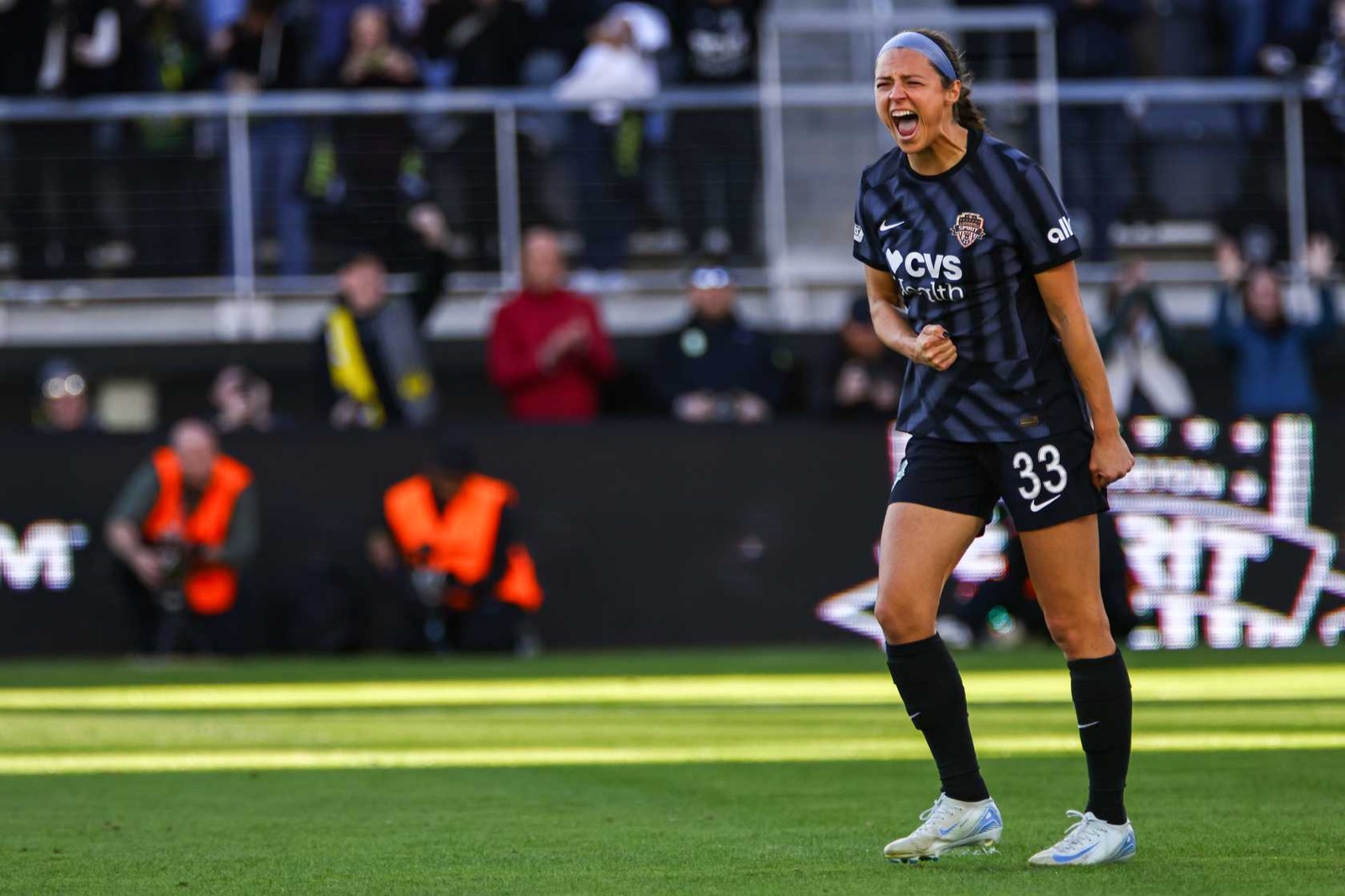 Ashley Hatch shouting in celebration on the field in a Washington Spirit match.